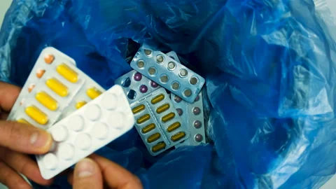 Throw the pills into the trash can. selective focus. Stock Footage 150311824