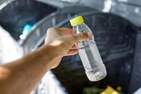 Throw a plastic bottle in the trash, taking care of cleanliness Stock Photos