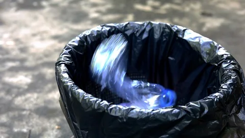 Throw the plastic bottles into the trash. Stock Footage 119324678