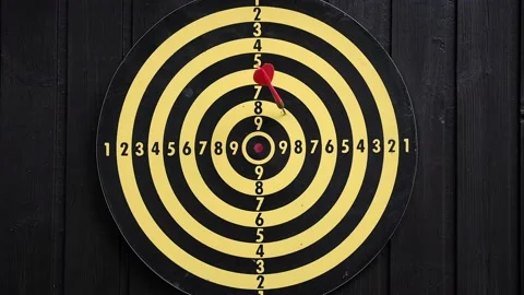 Throw red and yellow darts at the dart board Stock Footage 159585001