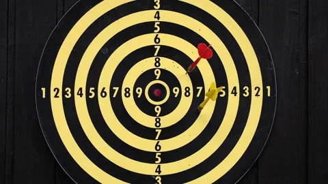 Throw red and yellow darts at the dart board Stock Footage 159585006