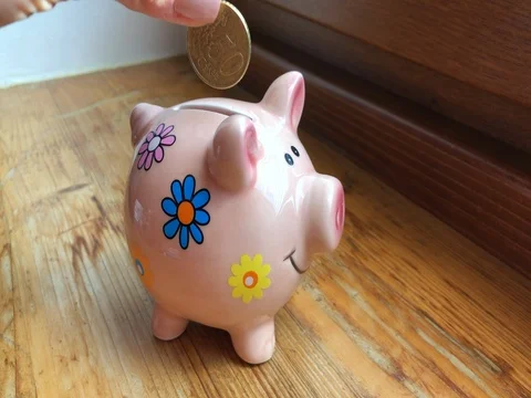 Throwing 50 euro-cent into a pig money-box Stock Footage 85041440