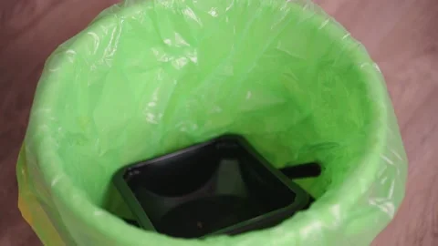 Throwing away dirty black plastic boxes from food delivery in green trash bag Stock Footage 153511277