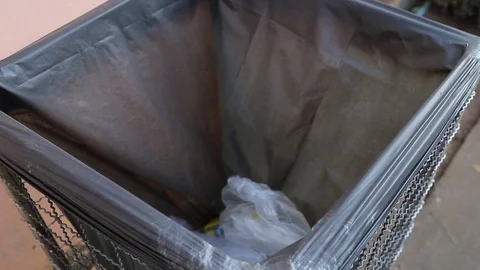 Throwing away garbage in public trash can, video Stock Footage 78330381