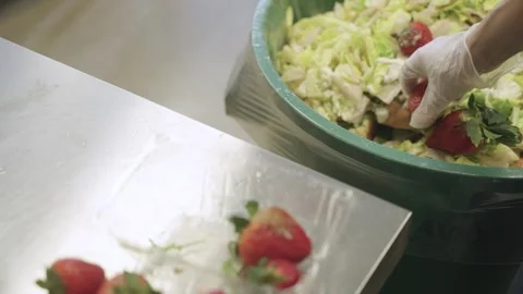 Throwing away moldy strawberries into bin. 動画素材 305586999