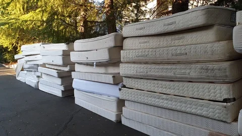 Throwing away old mattresses Stock Footage 98817976