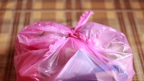 Throwing bottle into garbage package and taking it away 動画素材 76995982