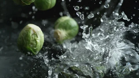 Throwing brussels sprout into water. Slow Motion. Stock Footage 94079683