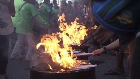 Throwing candles into a fire 動画素材 77708130