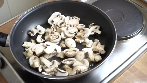 Throwing champingnons in the pan Stock Footage 79723597