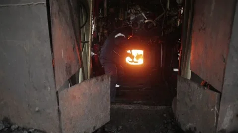 Throwing coal in a locomotive engine Stock Footage 64262072