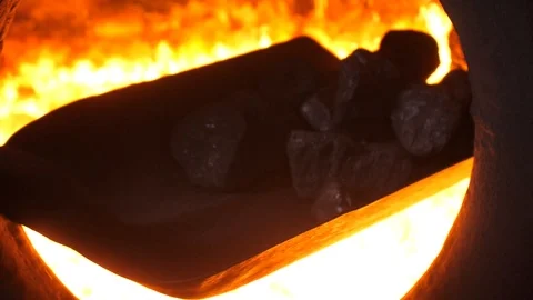 Throwing coals with shovel into the furnace Stock Footage