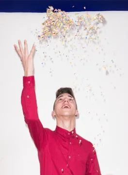 Throwing confetti, white background studio, one Caucasian teenager portrait,  Stock Photos