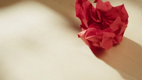 Throwing crumpling red paper close-up. Macro shooting of crumpled sheet. Stock Footage 169237211