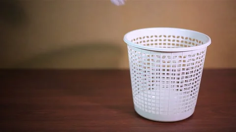 Throwing crushed paper into empty garbage can Stock Footage 58027777