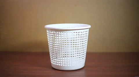 Throwing crushed paper into empty garbage can 動画素材 58028256