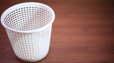 Throwing crushed paper into empty garbage can  Stock Footage 58028521