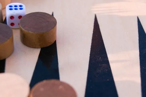 Throwing dice in backgammon board game close up, selective focus. Foreground  Stock Photos