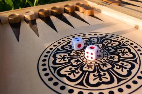 Throwing dice in backgammon board game close up, selective focus Stock Photos