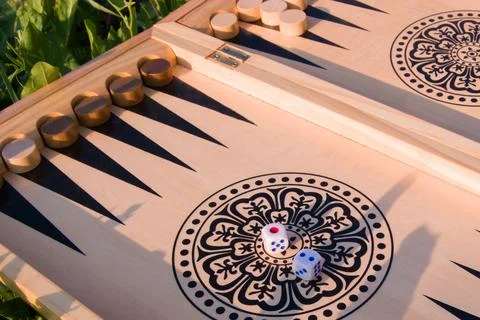 Throwing dice in backgammon board game close up, selective focus Stock Photos