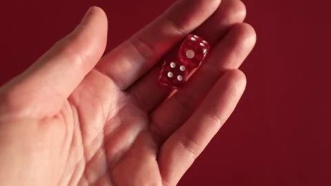 Throwing the dice. Red cubes with white dots on red background Stock Footage 326243109