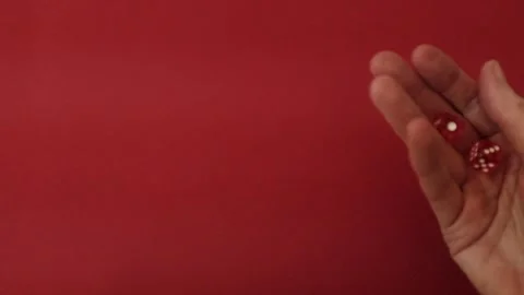 Throwing the dice. Red cubes with white dots on red background Video stock 326243138