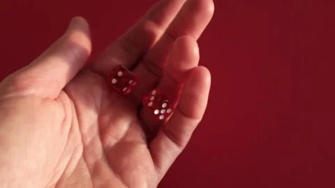Throwing the dice. Red cubes with white dots on red background Stock Footage 326243160