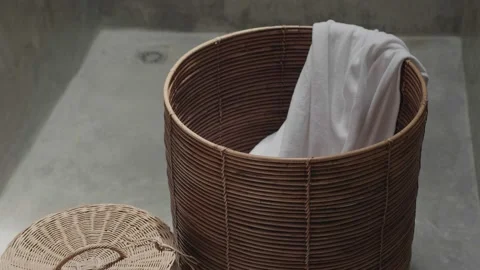 Throwing dirty laundry inside laundry basket Stock Footage 172370327
