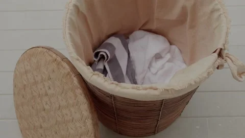 Throwing dirty laundry inside a laundry basket Stock Footage 172442365