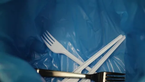 Throwing disposable plastic waste into the blue trash bag. Close-up Stock Footage 144121041