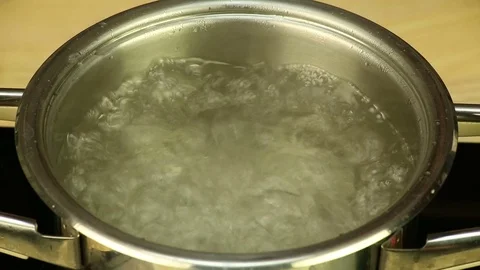 Throwing dumplings into the pot of boiling water  Stock Footage 72771048