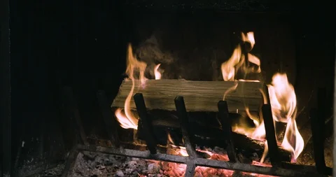 Throwing firewood into the fireplace Stockbeeldmateriaal 97876134