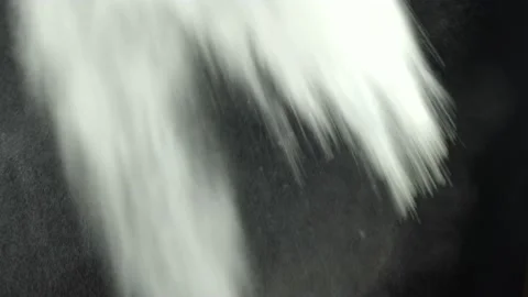 Throwing flour on a black background. White dust explosion effect Stock Footage 237480549