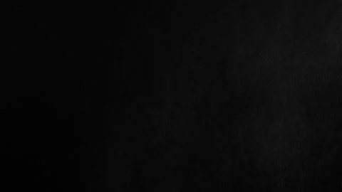 Throwing flour on a black background. White dust falling effect. Stock Footage 303140333