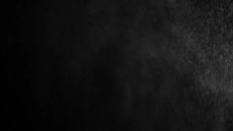 Throwing flour on a black background. White dust falling effect. Stock Footage 303140459