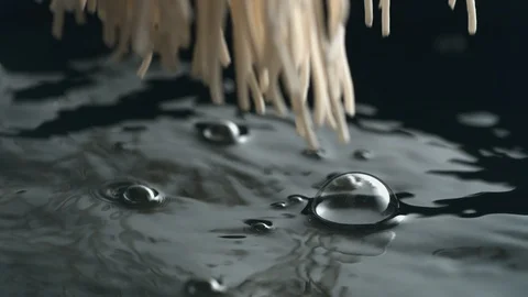 Throwing fresh noodle into boiling water. Slow Motion. Stock Footage 94082802
