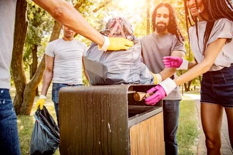 Throwing garbage into the trash can. Stock Photos