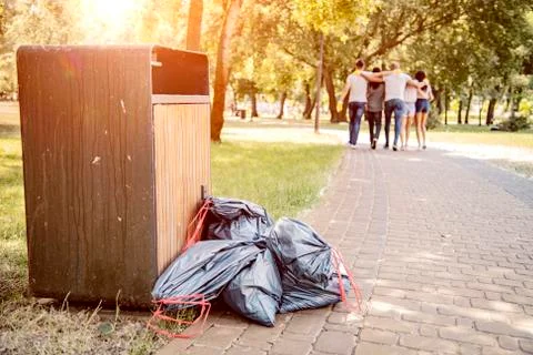 Throwing garbage into the trash can. Stock Photos
