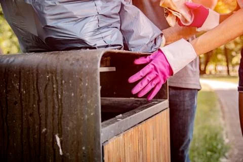 Throwing garbage into the trash can. Stock Photos