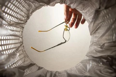 Throwing glass in the trash inside view. Vision correction Fotos Stock