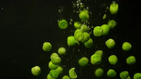 Throwing a green pea into the water in the background video. Video stock 255794247