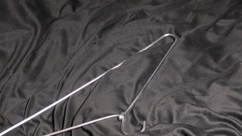 Throwing hangers on the black background. Video stock 128199219