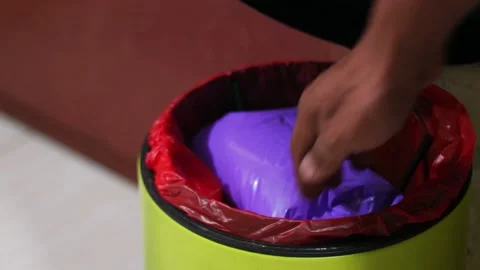 Throwing Household Waste into Trash Bin in Close Up Stock Footage 339002224