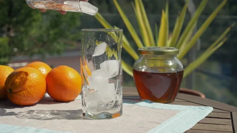 Throwing ice cubes in a glass close up Stock Footage 153983446