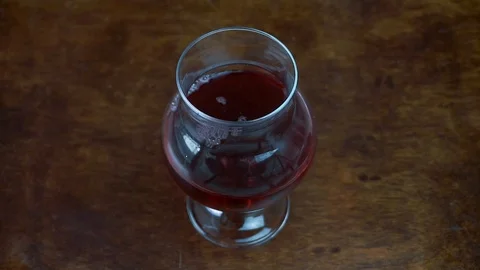 Throwing ice cubes into red wine glass.  Alcoholic beverage concept 動画素材 108305675