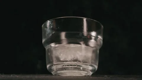Throwing ice in a glass medium cinematic shot Stock Footage 339843254