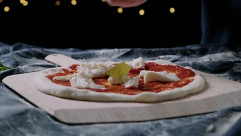 Throwing ingredients on a pizza Stock Footage 132834875