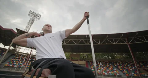 Throwing a kettlebell with his hand at a distance Paralympic strong-spirited man Stock Footage 154257488