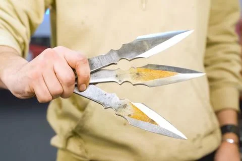 Throwing knife in hand aiming at target. Stock Photos