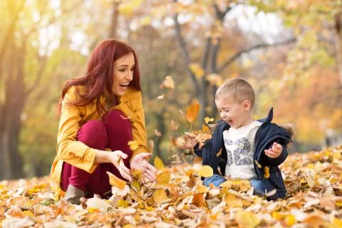 Throwing leaves in the park 写真素材